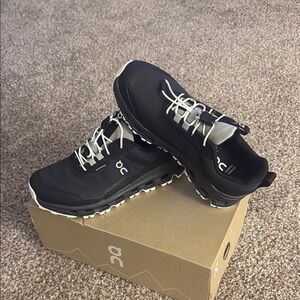On Running Black and White Athletic Shoes with Rugged Sole